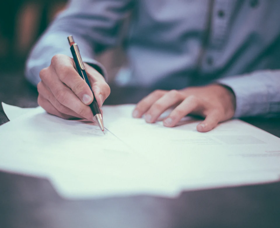 Customer signing an insurance policy document