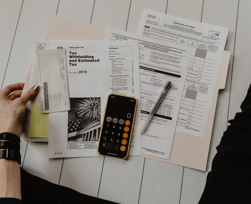 Loan and tax documents with a calculator