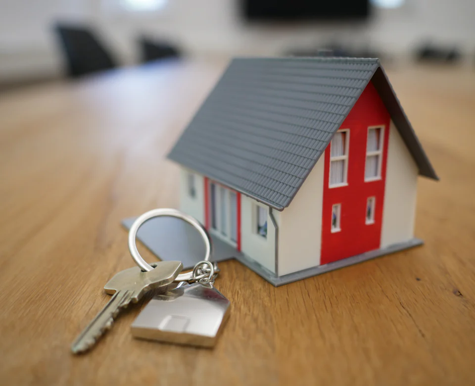 House keys next to a model home on a desk